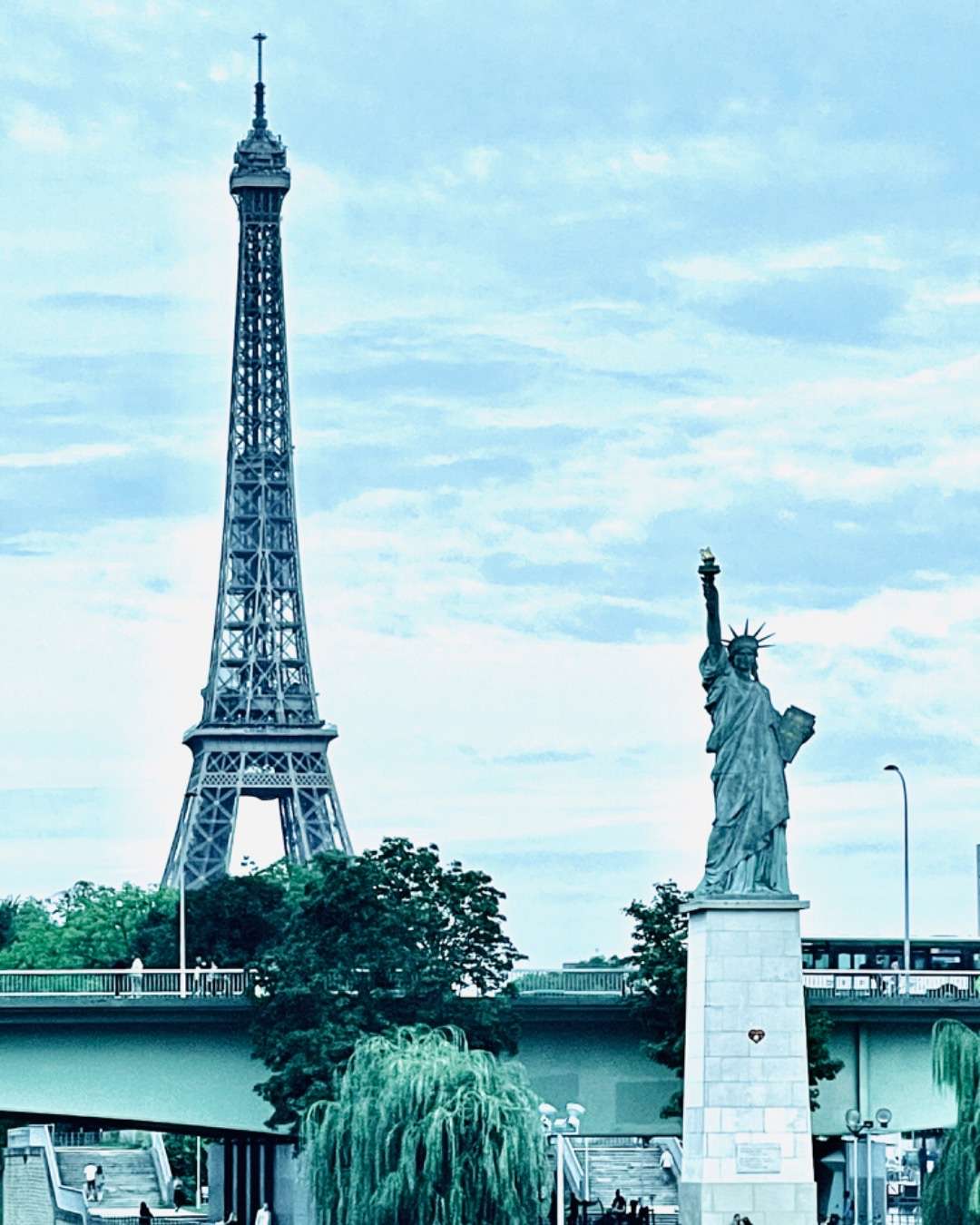 Eiffel tower with replica of Statue of Liberty across the river